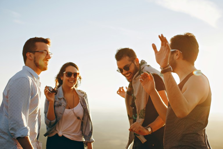 People smiling together, representing highly skilled migrants enjoying the 30% ruling tax advantage in the Netherlands.