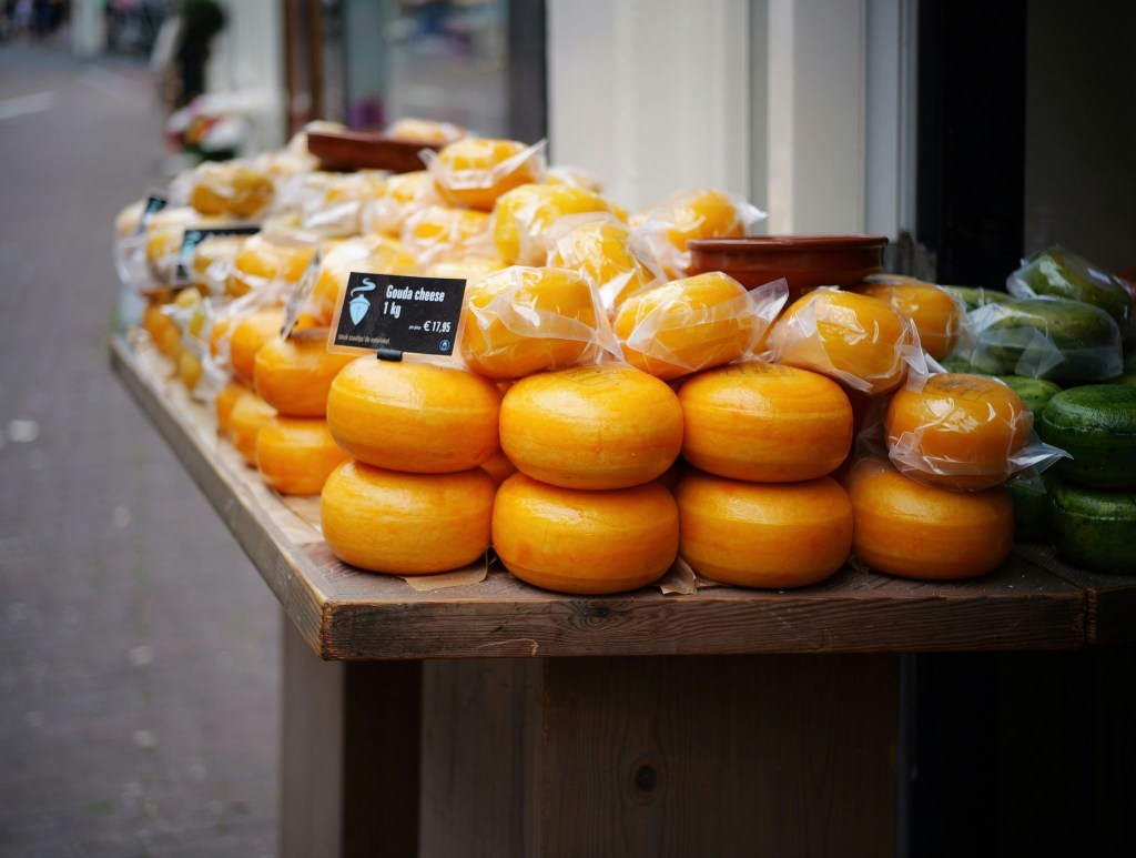 Cheese market in the Netherlands with wheels of Gouda cheese.