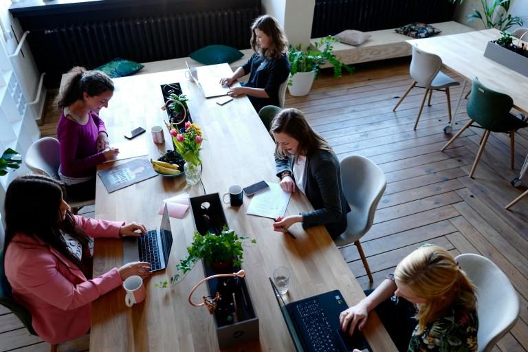 Employees working together at a desk while discussing the 30% ruling Netherlands.