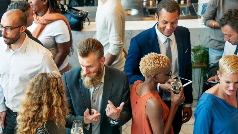 People talking on one of many corporate events planned by their company.