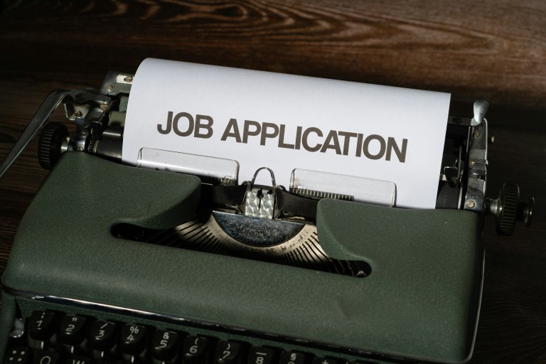 A paper with 'Job Application' written on it representing jobs in the Netherlands.
