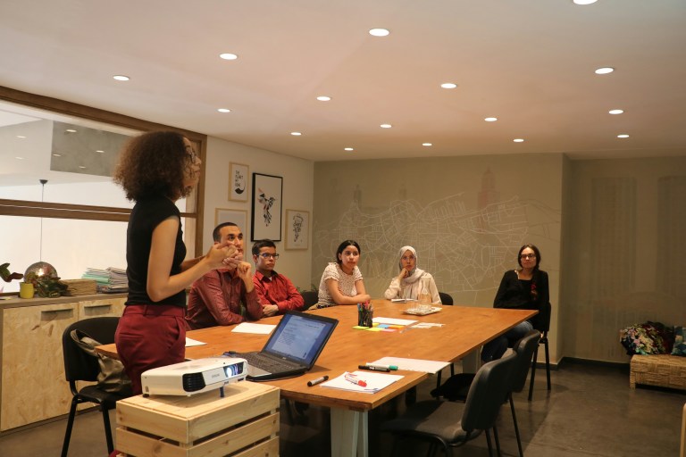 Staff training courses in action as diverse employees engage confidently with visitors in a welcoming institutional space.