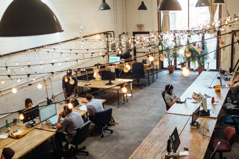 Professionals from diverse backgrounds collaborating through international HR solutions in an inclusive European workplace.