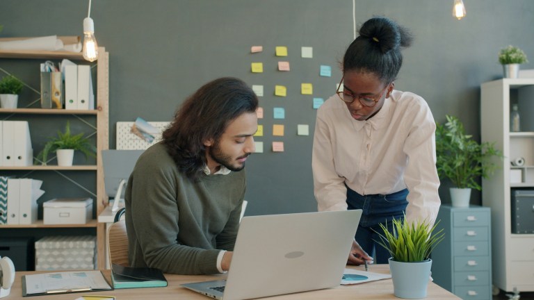 Startup founder reviewing payroll business solutions with an employer of record compliance checklist