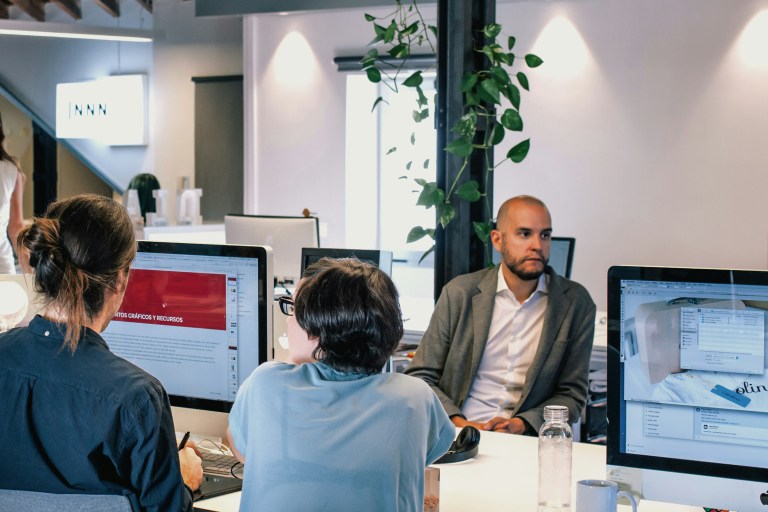 HR professionals collaborating in a global HR services office environment