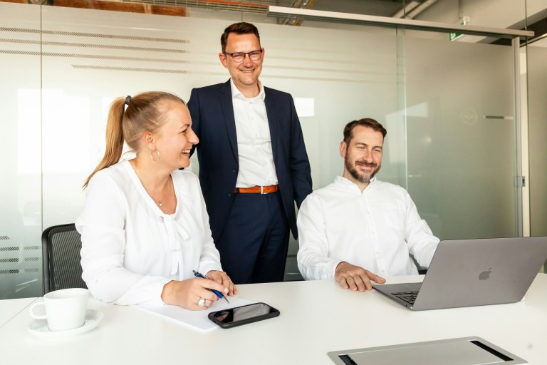 HR manager reviewing payroll and contracts with an employer of record Germany partner to hire staff without a GmbH.
